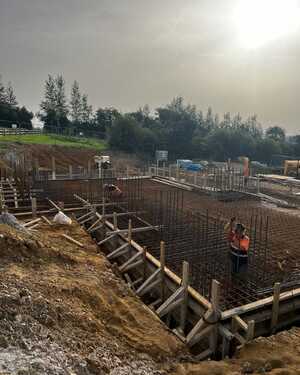 Foundations being prepared on a construction site under a hazy skyc